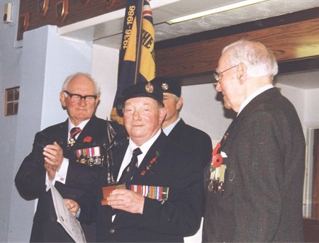 Bob Hammond receives a statuette of a Standard Bearer